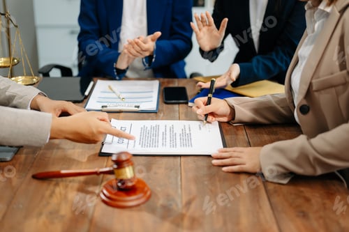Preview: Business and lawyers discussing contract papers with brass scale on desk in office. Law,