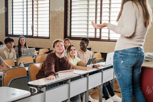 Preview: University students attending to the explanations of the teacher in class