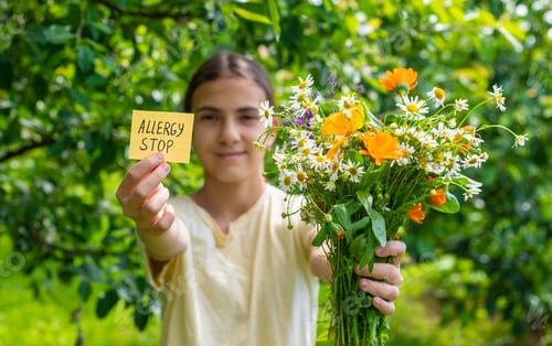 Preview: allergy to flowers in a child. Selective focus.
