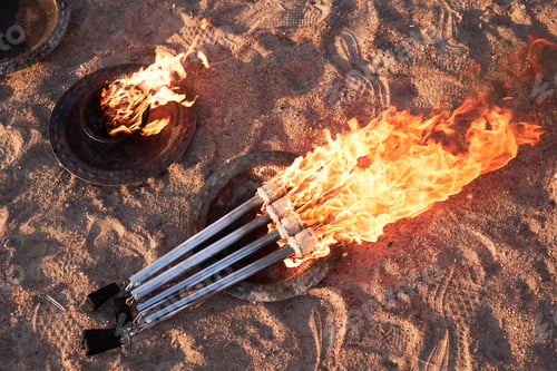 Preview: Top View Burning Fire Torches on Sand