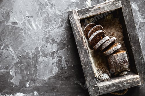 Preview: bread in an old wooden box already cut into pieces. food