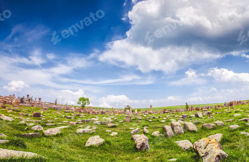 Preview: Stones on lawn and magnificent cloudy sky