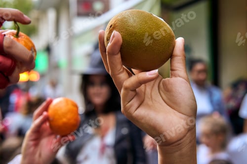 Preview: multiethnic kids hands showing fruits on a healthy trick or treat halloween event