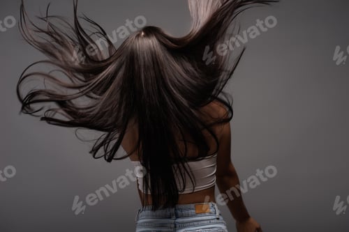 Preview: back view of brunette long haired woman isolated on black