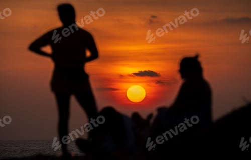 Preview: Enjoying the sunset view on the tropical beach in Galle. Silhouetted group of people