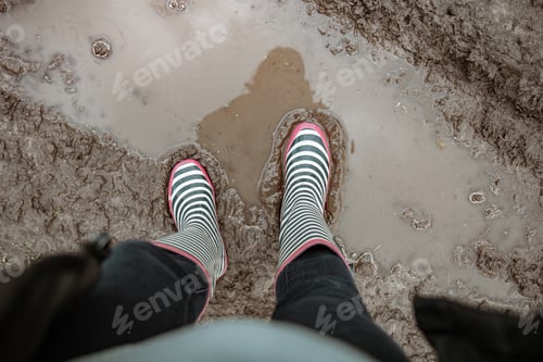 Preview: Close-up of rubber boots in a swamp top view.