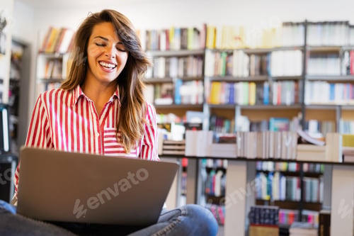 Preview: Portrait of happy student woman working on laptop
