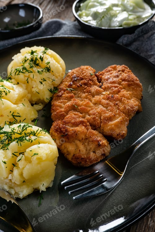 Preview: Pork chop served with mashed potatoes and cucumber salad.