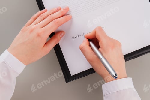 Preview: Woman Signing Document with Silver Pen Close-up