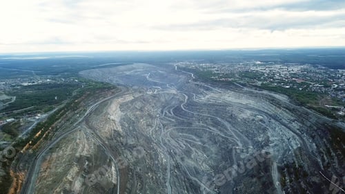Preview: Coal mining at an open pit. Top view of the quarry. Dozers and trucks at buildings site on top