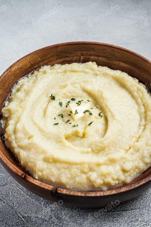 Preview: Boiled potato puree, Mashed potatoes in a wooden plate. White background. Top view