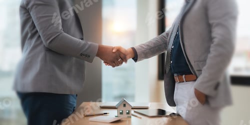 Preview: Close up of African American business man and Indian man shaking hands while at the office with