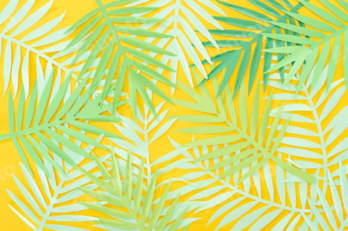 Preview: top view of paper cut green tropical leaves scattered on yellow bright background
