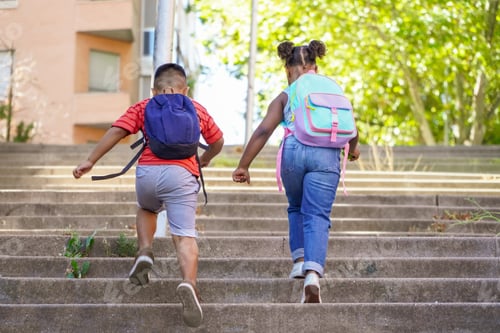 Preview: multiethnic kids with backpacks running on the street back to school