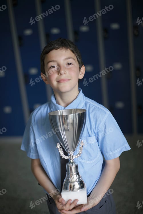 Preview: School boy holding trophy