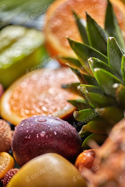 Preview: Tropical fresh background with exotic Passion fruit in a droplets of water and green pineapple