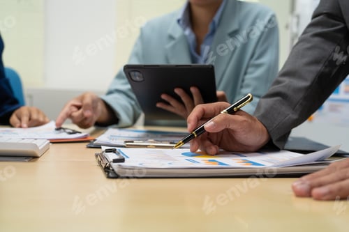 Preview: A businessperson financial analyst during corporate meeting. review a graph document,discussing