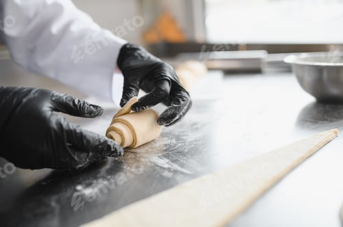 Preview: Baker making croissant dough in bakery kitchen