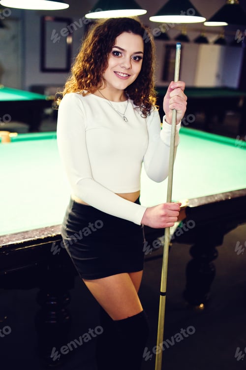 Preview: Young curly girl posed near billiard table