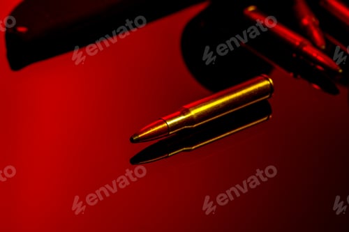 Preview: Rifle cartridges on glass background in red light