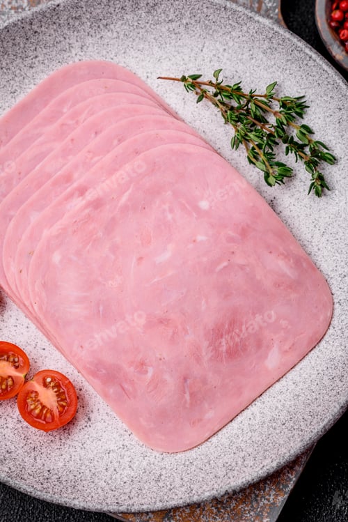 Preview: Delicious fresh ham cut into slices with salt, spices and herbs