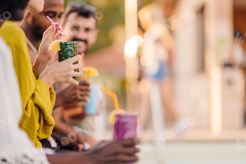 Preview: Friends enjoying refreshing cocktails by the poolside during summer vacation