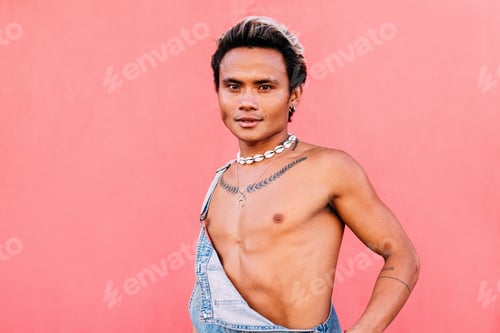 Preview: Portrait of a young male in overalls looking at camera