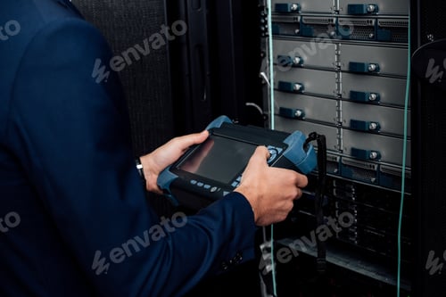 Preview: cropped view of man holding reflectometer in server room