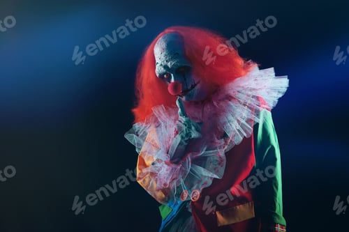 Preview: Terrifying clown on black background. Halloween party costume