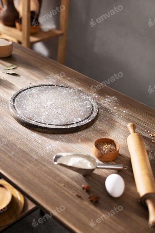 Preview: Wheat flour powder and pizza board for homemade bread cooking or baking on table. Food bread recipe