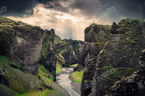 Preview: Fjadrargljufur canyon with river Fjadra flowing through and dramatic sky in summer at Iceland