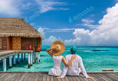 Preview: Couple in white on a tropical beach jetty
