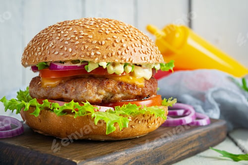 Preview: Homemade classic hamburger with beef cutlet, cheese, lettuce and tomato on wooden background