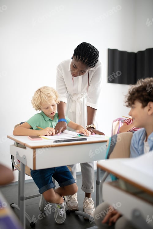 Preview: Boy answering question of teacher standing near him