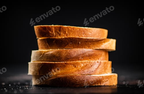 Preview: Sliced wheat bread. On a black background.