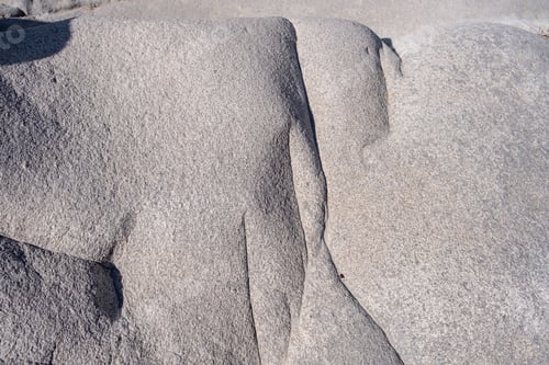 Preview: Granite grey rock shaped by the sea salt and wind background texture. Smooth mineral surface