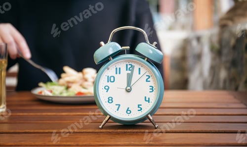 Preview: Close-up, alarm clock on a blurred food background.