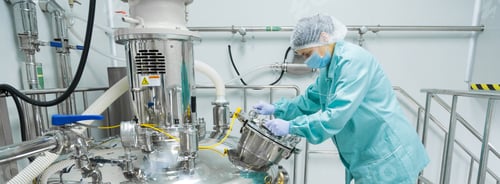 Preview: Pharmaceutical factory woman worker in protective clothing operating production line in sterile