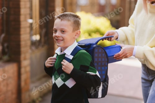 Preview: mom gives food to the child to school, back to school concept