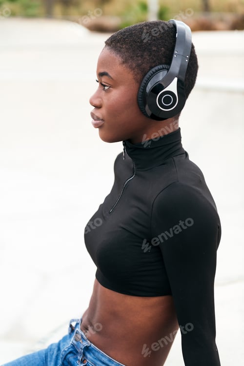 Preview: Dreamy black woman in headset resting on platform