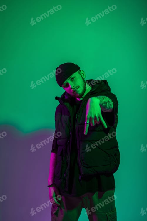 Preview: Handsome man dancer in fashion clothes in studio