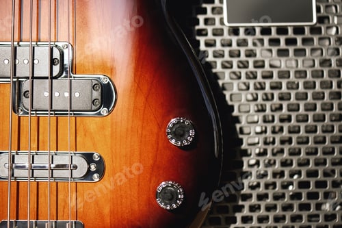 Preview: Music and entertainment. Close up detailed view of a brown electric guitar body and amplifier
