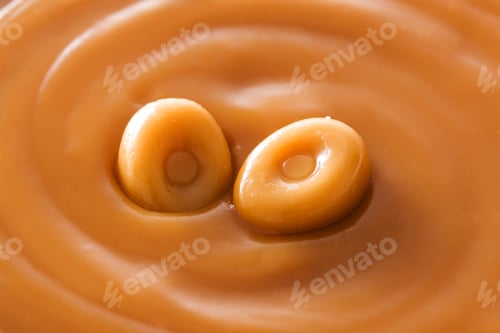 Preview: Two caramel candies melting into sweet sauce creating delicious swirls