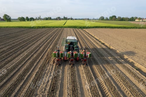 Preview: Aerial view of old tractor and semi Automatic tomato planter machine working in a field