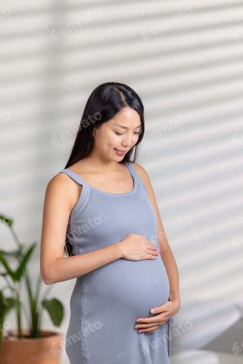Preview: Asian pregnant look at the tummy at home