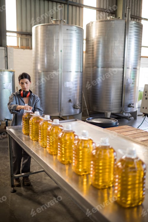 Preview: Female worker working in oil factory