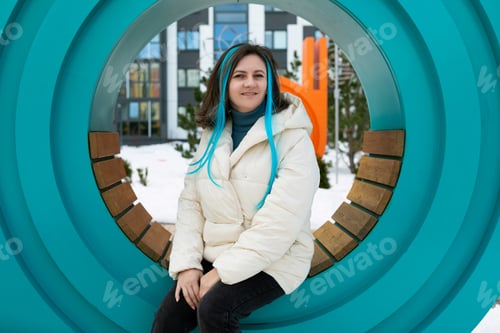 Preview: Woman Sitting on Bench in Front of Sculpture