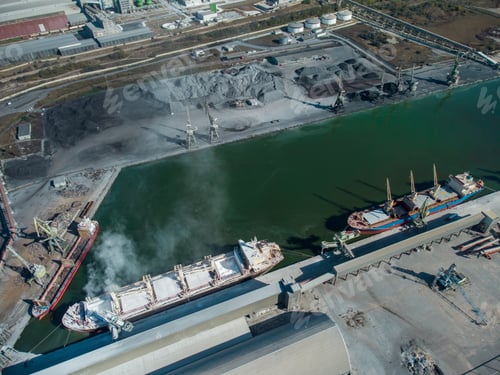 Preview: Aerial view of big cargo ship bulk carrier is loaded with minerals in port
