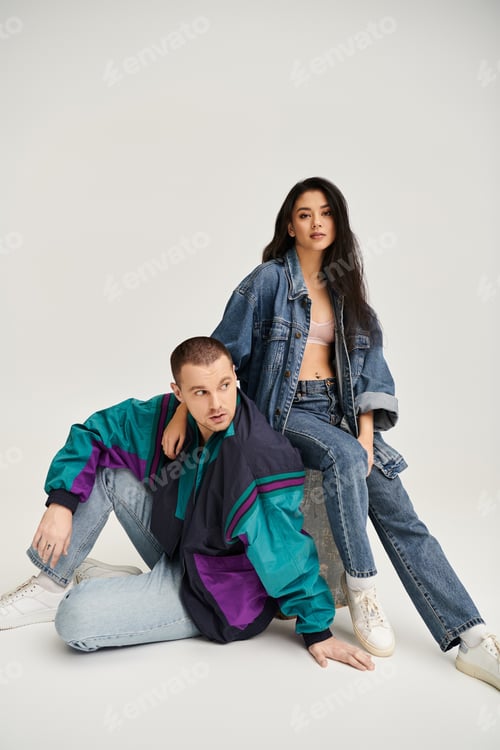 Preview: Young couple dressed in trendy outfits expresses their love in a studio, capturing romance.
