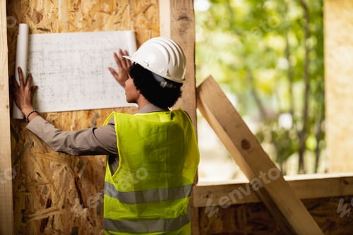 Preview: Black Woman Architect Checking Blueprints Project At Construction Site